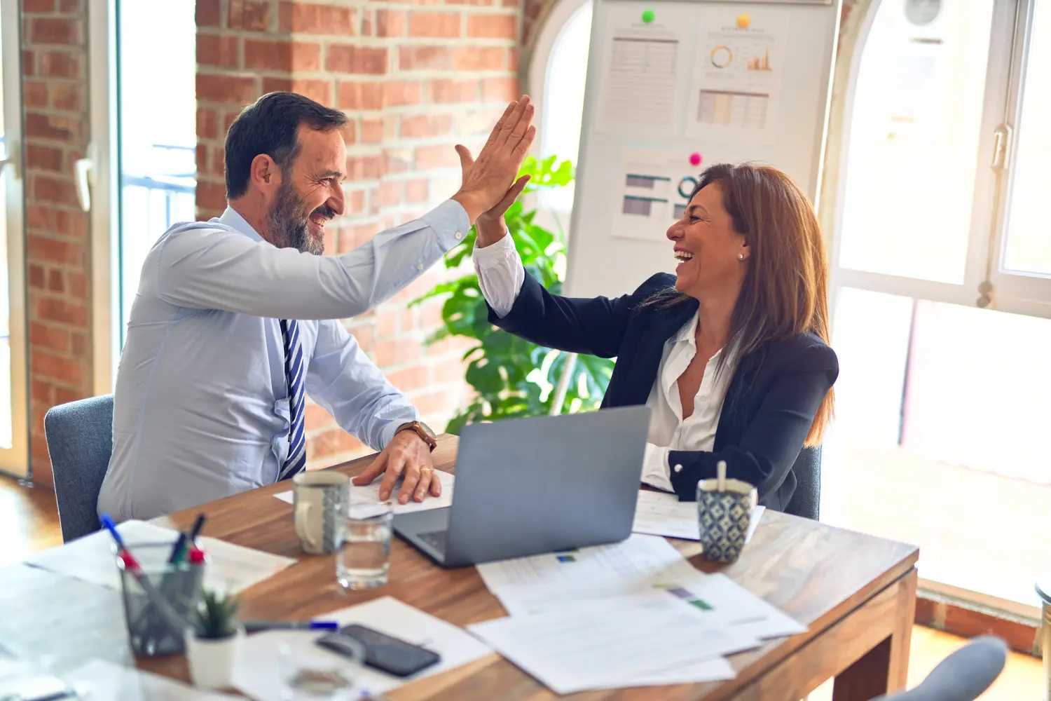 Man and women giving high five to each other